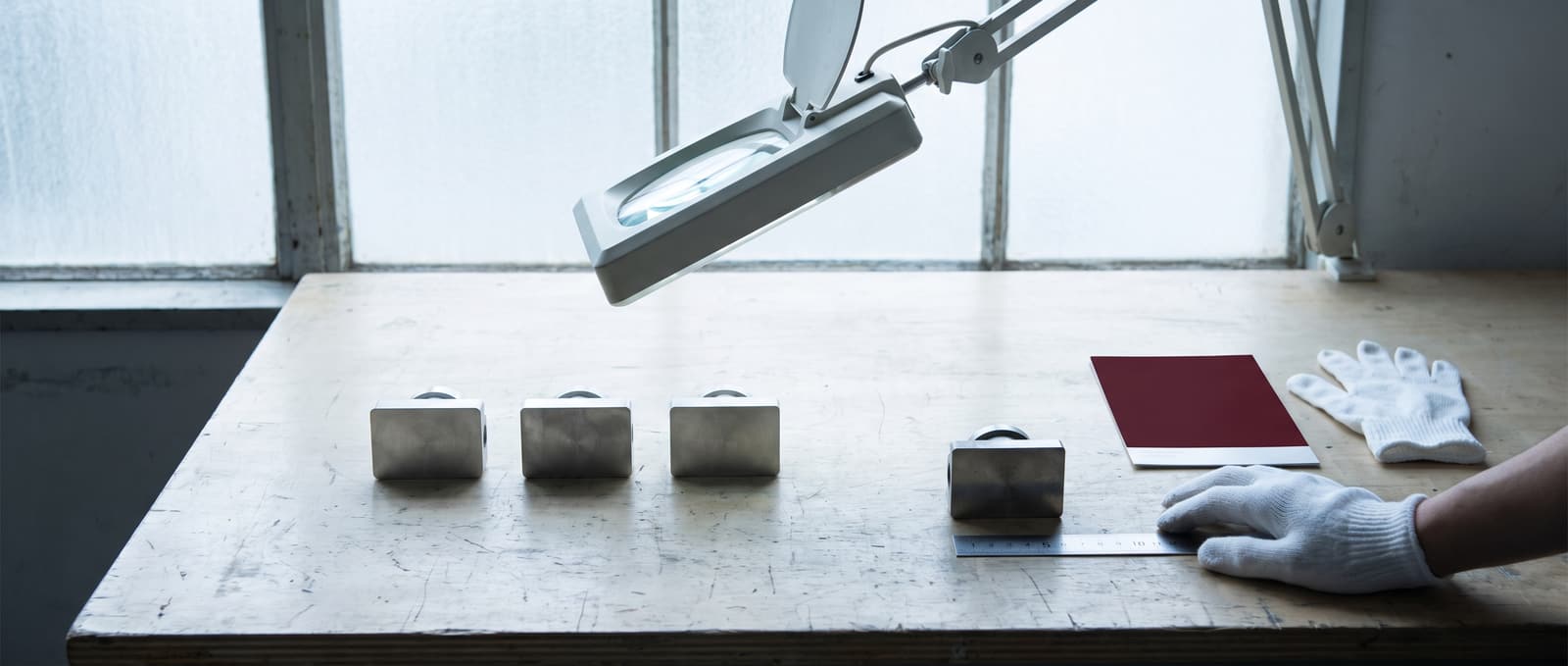Product samples under an inspection lamp with one set aside