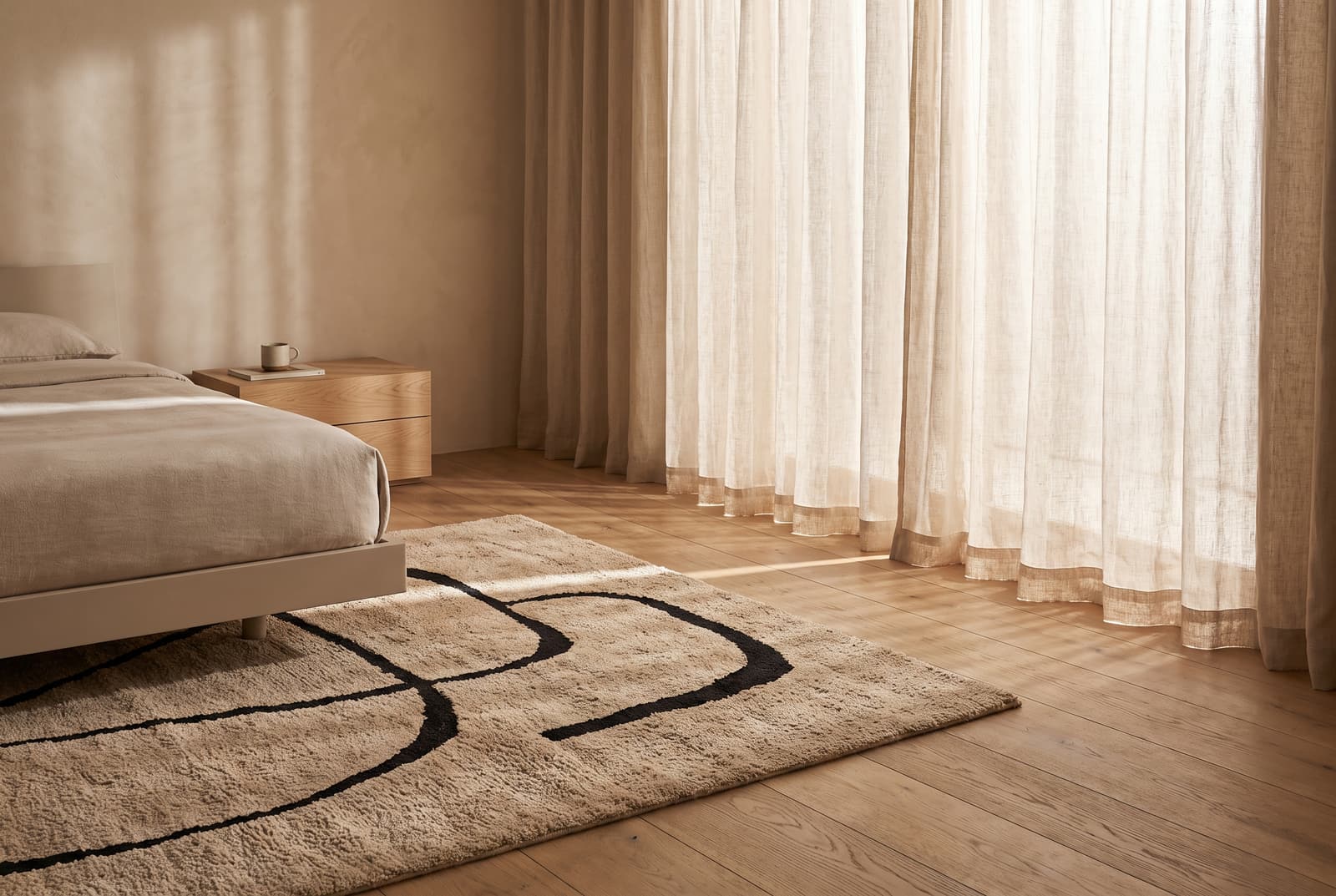 A tufted rug beside a bed in a calm contemporary bedroom